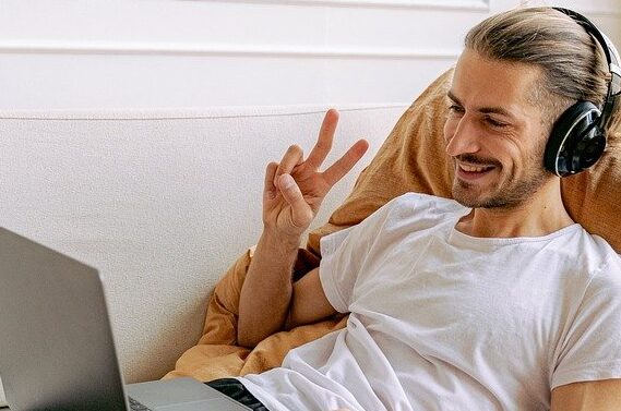 IMAGE OF MAN TALKING ON A LAPTOP